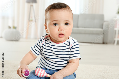 Cute little baby with rattl...
