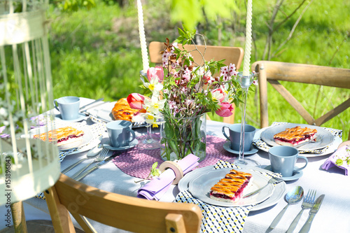Table setting with flowers in garden
