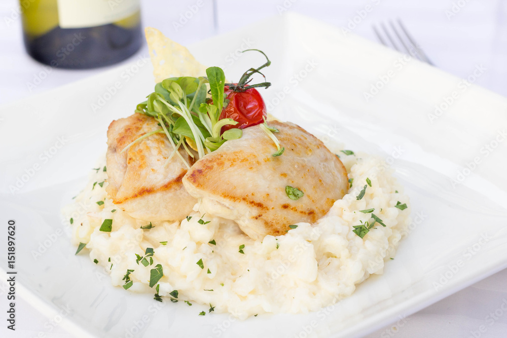 Risotto with chicken served in a restaurant. Risotto with chicken served in a restaurant.