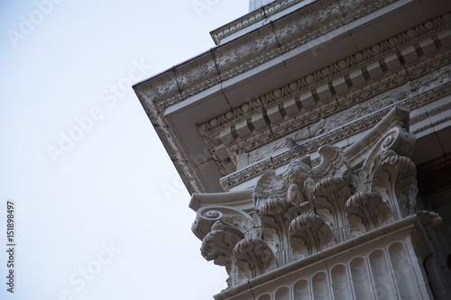 Dramatic Upward Skyward Angled View, Corner of Ornate Building, Architectural, Dentil Trim, Ball and Dart Frieze, Eagle, Corinthian Columns, Shells, Leafs, Daytime - West Coast. USA photo