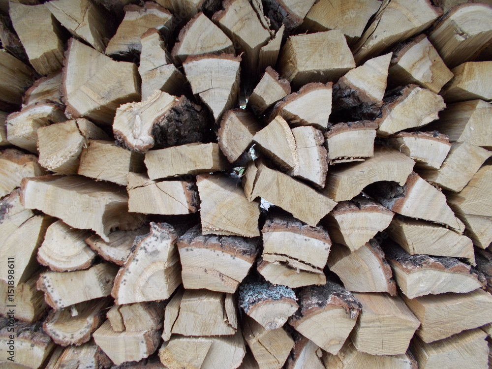 Woodpile of cut Lumber for forestry industry.Woodpile of cut trees in the lumber yard. Grey Background and texture with space for text or image.