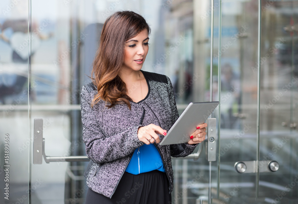 attractive businesswoman using a tablet computer attractive businesswoman using a tablet computer