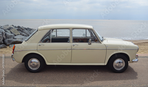  Classic Cream  Coloured  Austin 1100 MG Motor Car parked on seafront promenade.