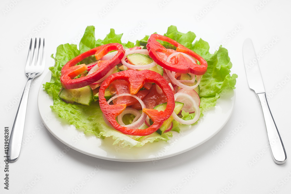 Vegetable Salad as a heart, vegetarian, lettuce, pepper, cucumber, radish, onion, tomato, celery, fork knife, white background

