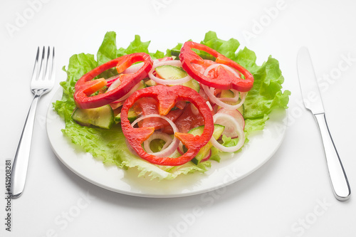 Vegetable Salad as a heart, vegetarian, lettuce, pepper, cucumber, radish, onion, tomato, celery, fork knife, white background 