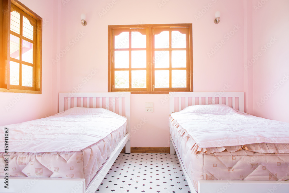 pink bedroom with two bed