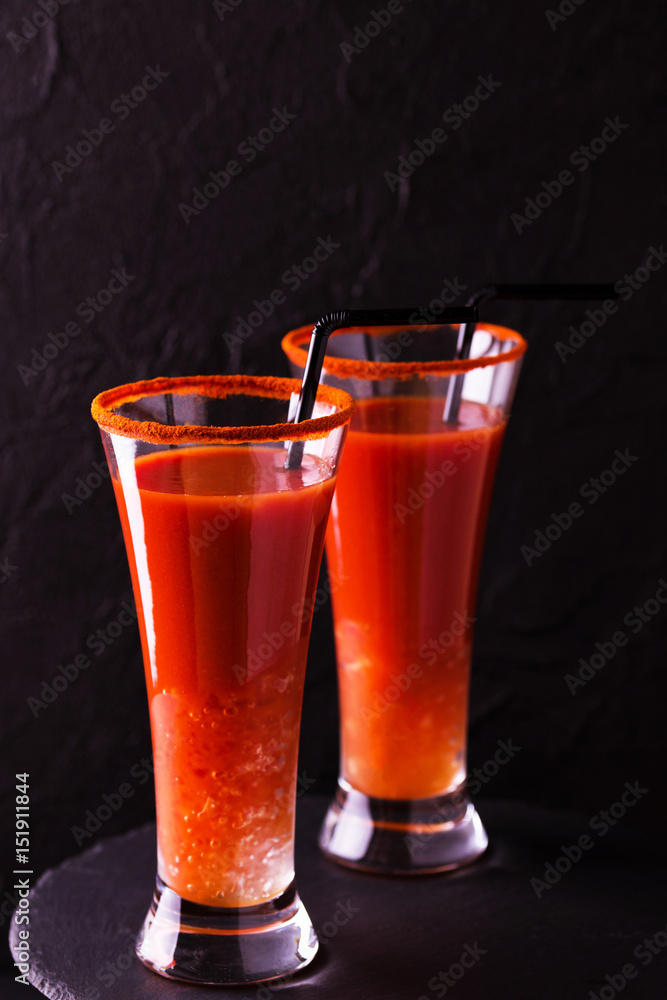 Bloody Mary cocktail with chili pepper, ice and celery. Bloody Mary cocktail with chili pepper, ice and celery.