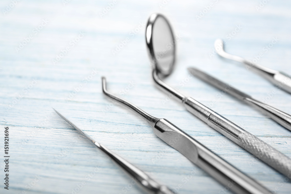 Set of dentist tools on wooden background Set of dentist tools on wooden background