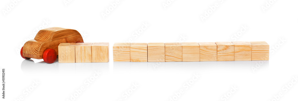 Cubes with space for text and wooden toy car on white background