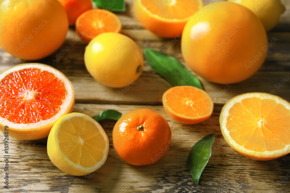 Fresh assorted citrus fruits on wooden background