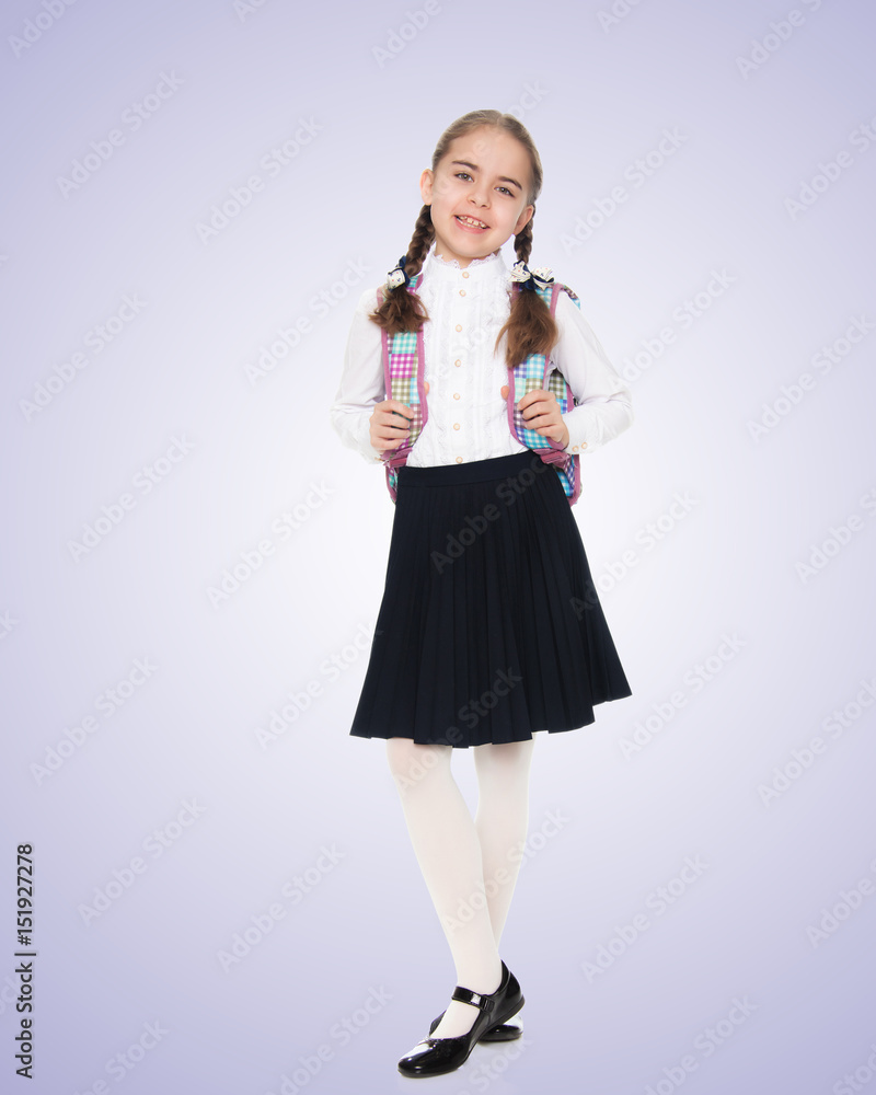Beautiful schoolgirl with a backpack behind her shoulders. Beautiful schoolgirl with a backpack behind her shoulders.