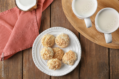 Plate with delicious coconut macaroons on table