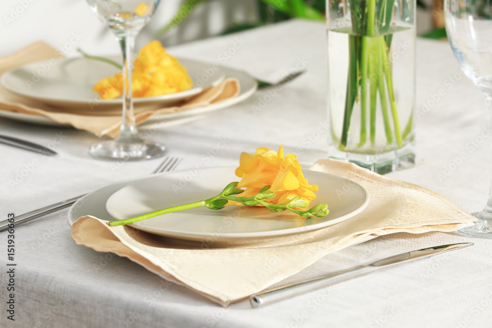 Beautiful festive table setting and flower in light room Beautiful festive table setting and flower in light room