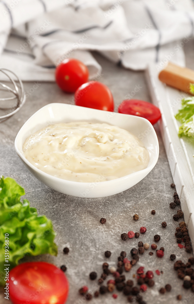 Delicious mayonnaise in bowl on kitchen table Delicious mayonnaise in bowl on kitchen table