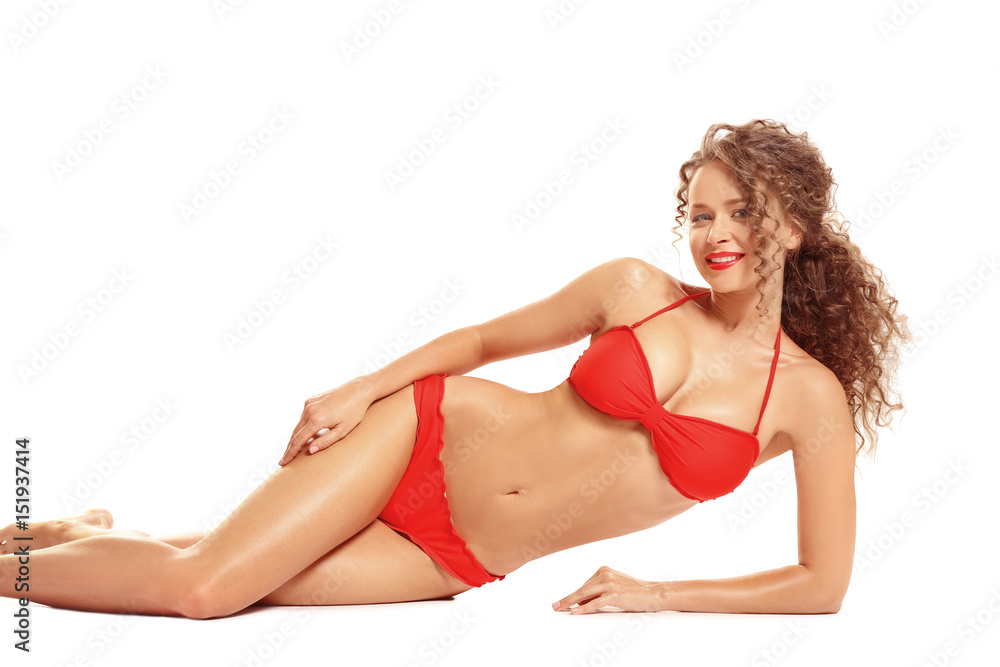 Obraz premium Beautiful young woman in bikini on white background