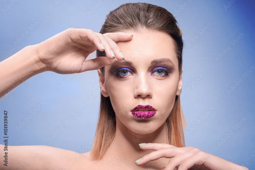 Beautiful young woman with creative makeup on color background Beautiful young woman with creative makeup on color background