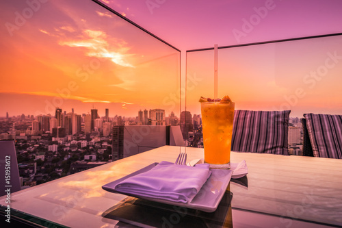 Photography abstract yellow cocktail on rooftop bar and cityscape view - can use to display