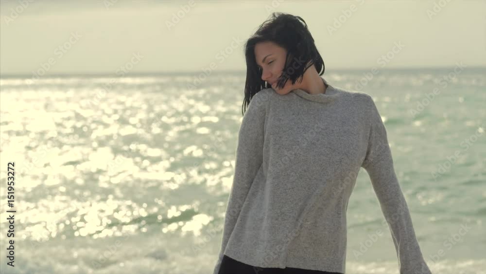 Portrait of a young brunette smiling woman enjoying walk on the sea beach. Real close-up face of lady with green eyes. 4k Portrait of a young brunette smiling woman enjoying walk on the sea beach. Real close-up face of lady with green eyes. 4k