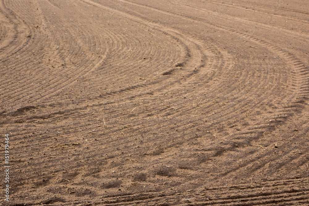 Plowed field. Drawing on the ground furrows and traces of tractor tires. Early Spring on Podlasie, Eastern Poland. Plowed field. Drawing on the ground furrows and traces of tractor tires. Early Spring on Podlasie, Eastern Poland.