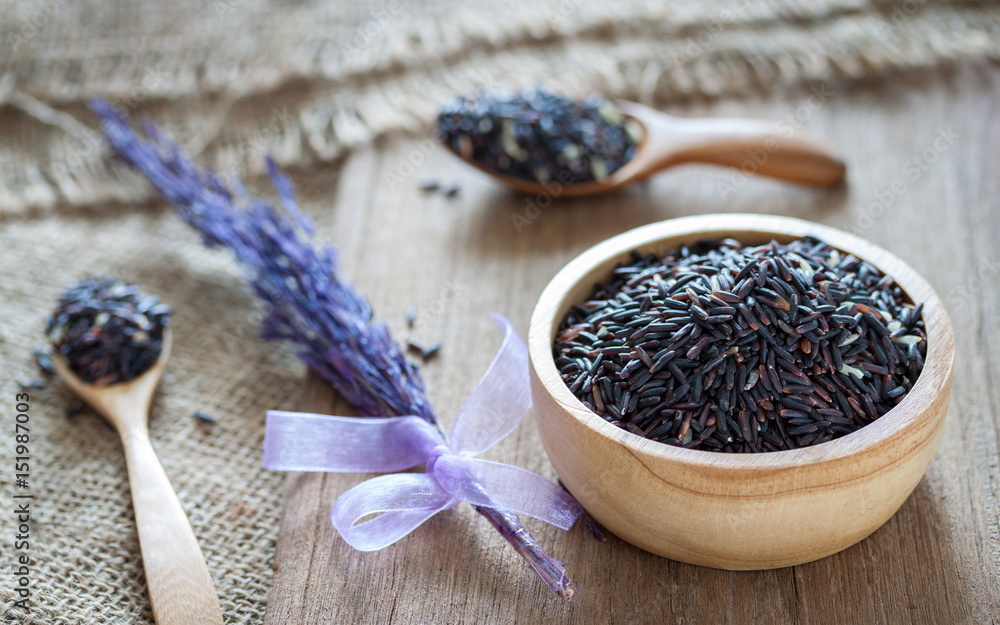 Rice berry in a bowl on wooden background Rice berry in a bowl on wooden background