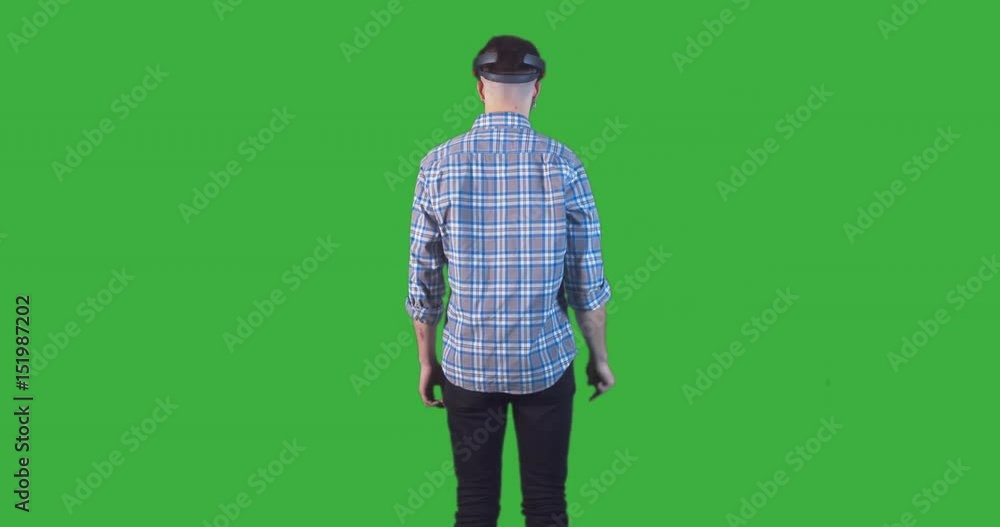 Young adult Caucasian male using holographic augmented reality glasses. Green screen chroma key. Right side key light. 4K UHD RAW edited footage Young adult Caucasian male using holographic augmented reality glasses. Green screen chroma key. Right side key light. 4K UHD RAW edited footage