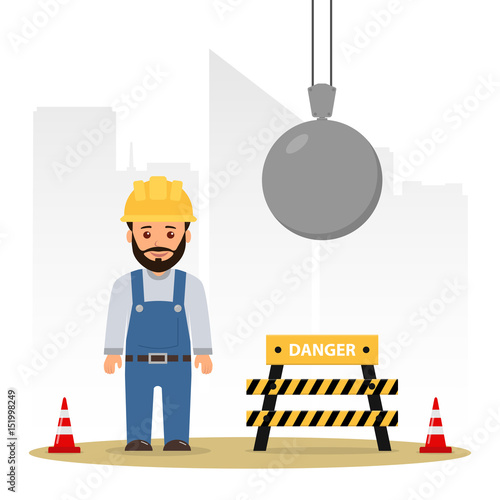 Builder at a construction site. Demolition of the building. Wrecking ball.
