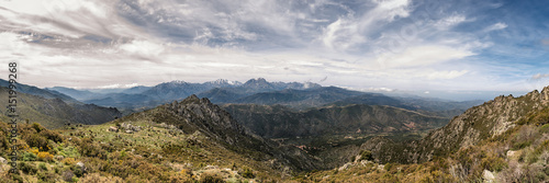 Dramatic panoramic view of snow capped mountains of northern Corsica