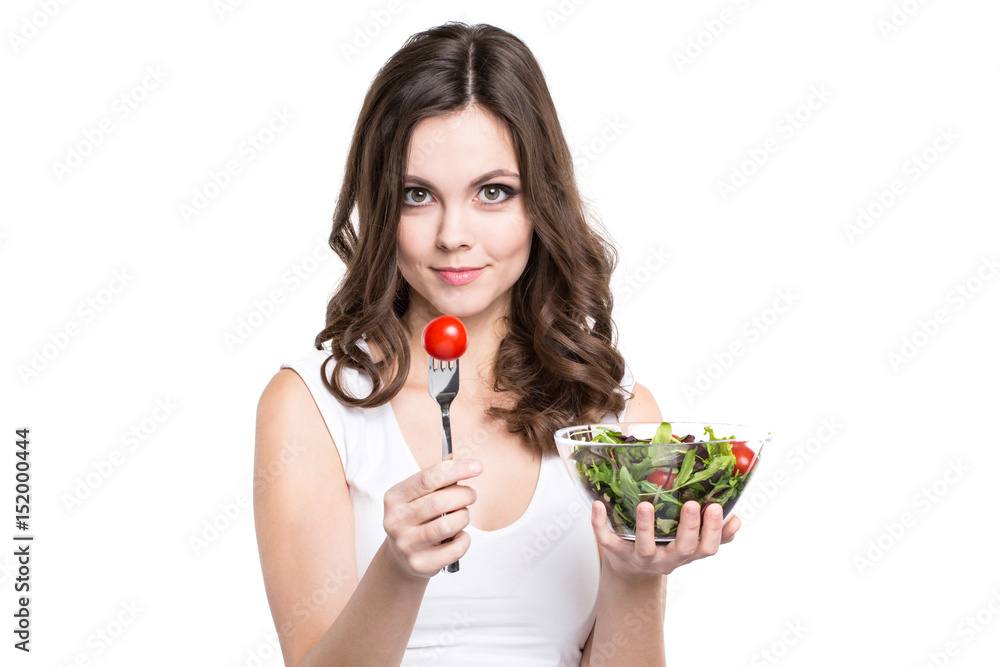 Portrait healthy woman eating a fresh salad isolated. Portrait healthy woman eating a fresh salad isolated.