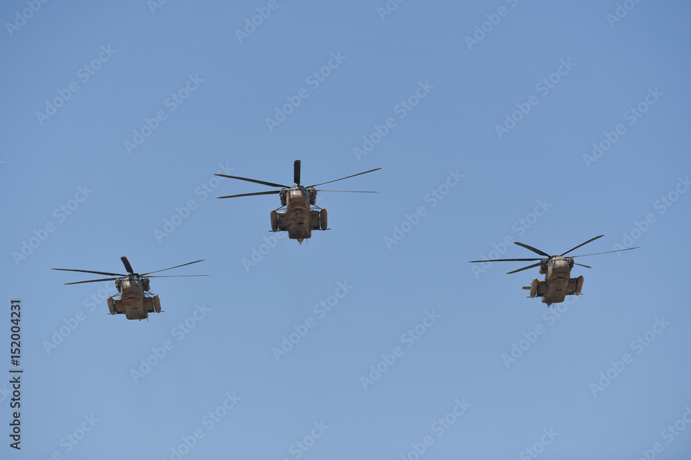 Fototapeta premium Synchronized flight of 3 military helicopters in the team during Israeli 69st independent day
