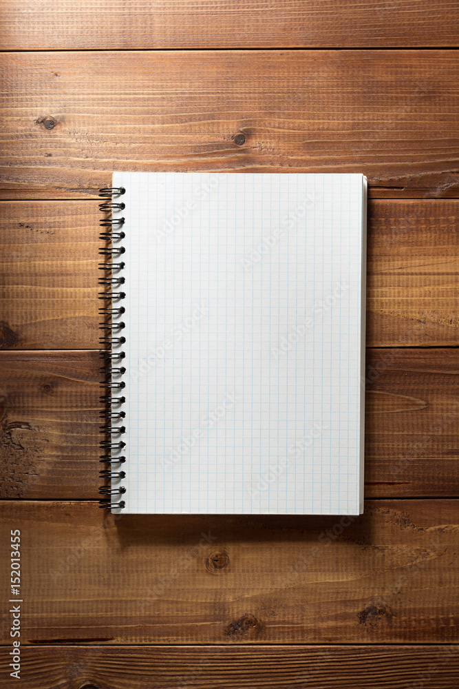 Foto checked notebook on wooden background