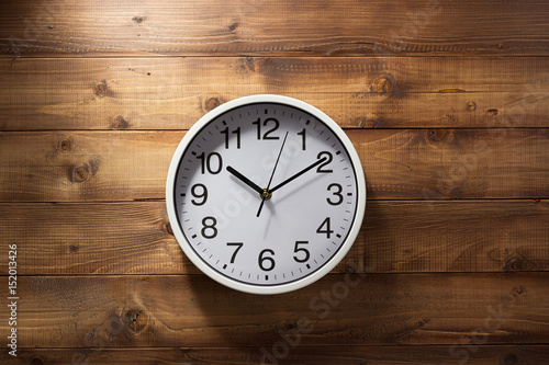 wall clock at wooden background