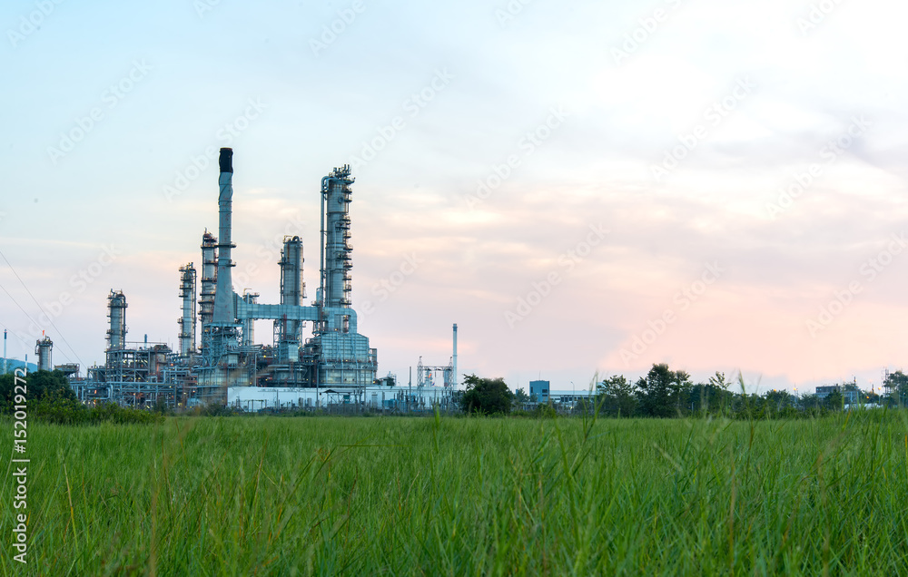 Oil refinery plant at sunrise with sky background