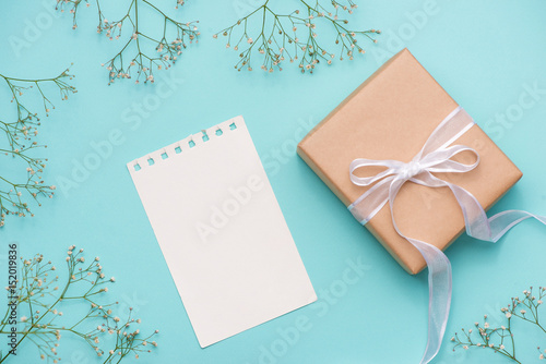 Kraft paper gift box tied with white ribbon and flowers for mothers day © makistock