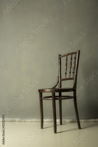 old wooden chair on Grey grunge textured handmade background wall Copy space.for portrait