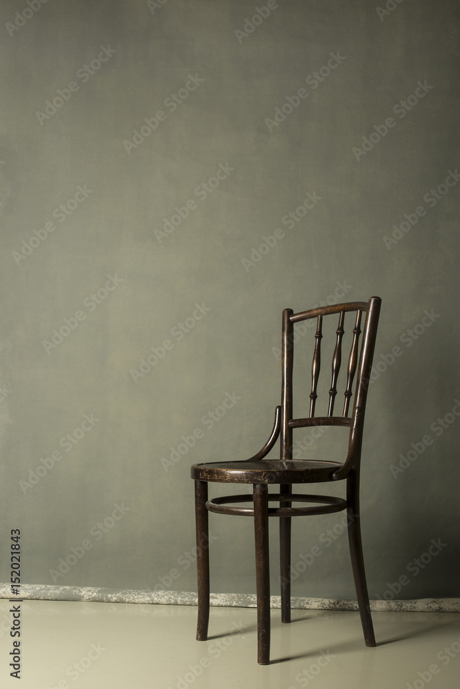 old wooden chair on Grey grunge textured handmade background wall Copy space.for portrait old wooden chair on Grey grunge textured handmade background wall Copy space.for portrait