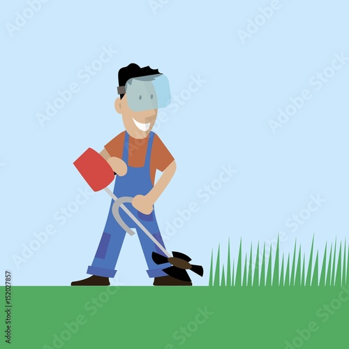 A worker cuts the grass in the garden
