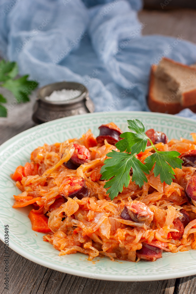 Cabbage stew with grilled sausage - traditional dish of german cuisine, Selective focus Cabbage stew with grilled sausage - traditional dish of german cuisine, Selective focus