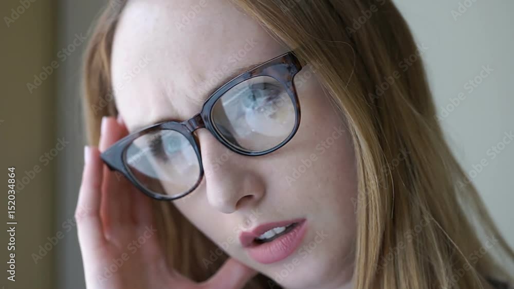 Pretty girl with glasses looks unhappy while having painful headache
Pretty girl with glasses looks unhappy while having painful headache