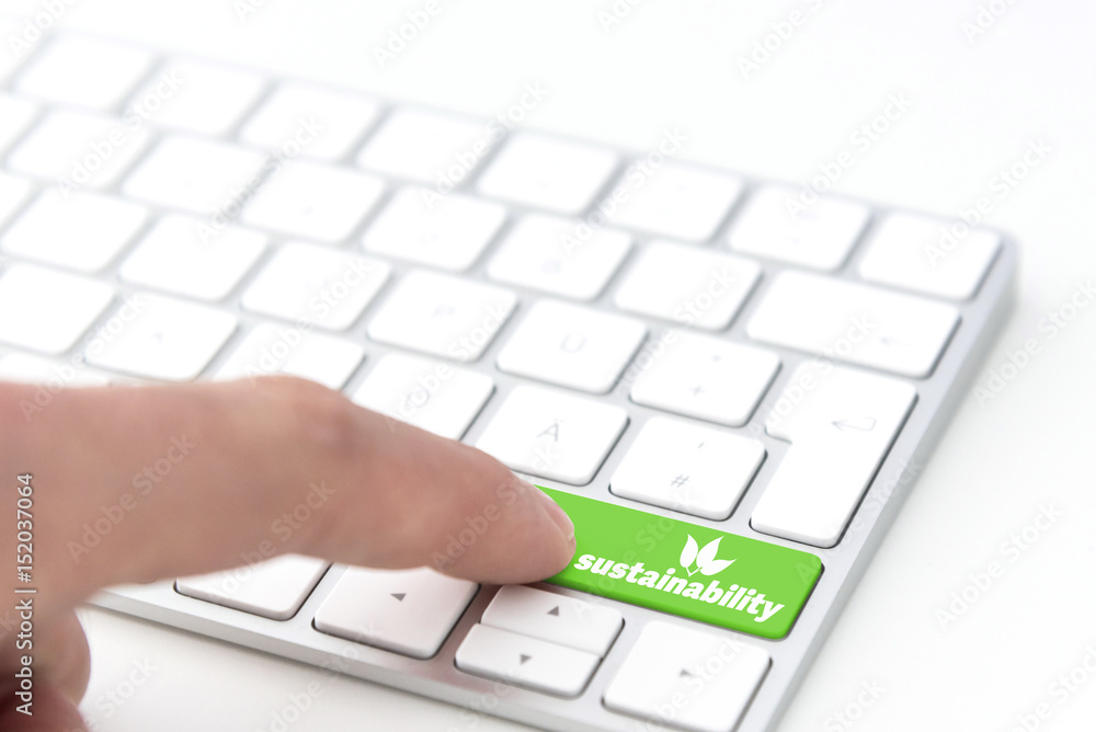 finger pressing a green key labeled SUSTAINABILITY with leaves symbol on a computer keyboard concept finger pressing a green key labeled SUSTAINABILITY with leaves symbol on a computer keyboard concept