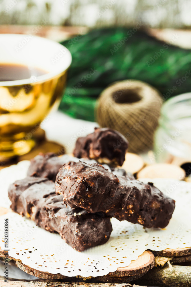 Homemade raw chocolate candy. Snickers bars with cup of coffee. Homemade raw chocolate candy. Snickers bars with cup of coffee.