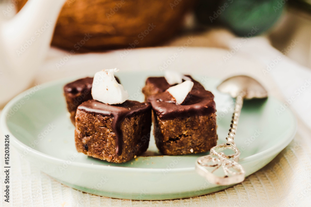 Raw chocolate candy with nuts and coconut, healthy vegan dessert Raw chocolate candy with nuts and coconut, healthy vegan dessert
