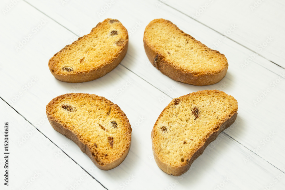 Fragrant crackers with raisins on a white wooden table, snack. Fragrant crackers with raisins on a white wooden table, snack.