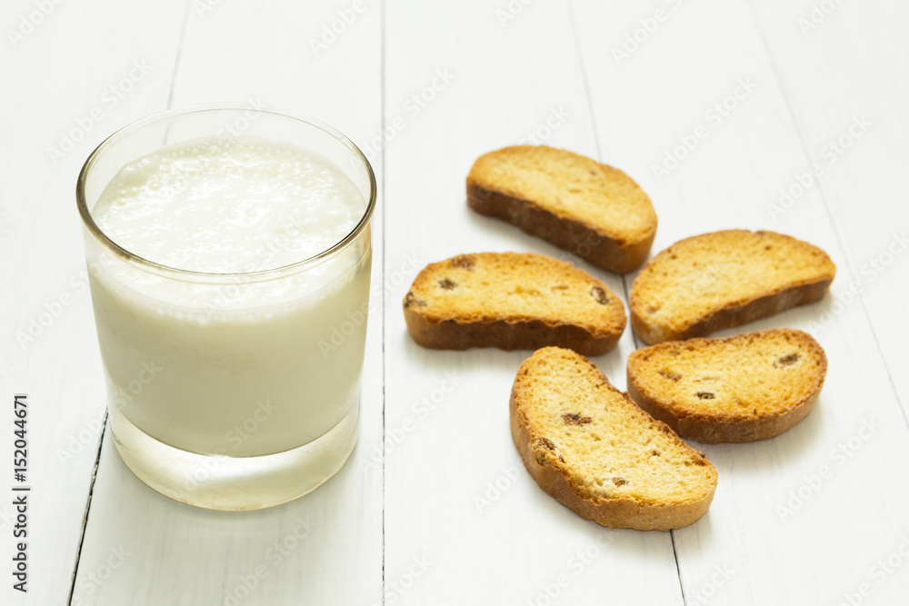 Dietary breakfast, sour yogurt in a glass cup and croutons with raisins on a white table, slimming. Dietary breakfast, sour yogurt in a glass cup and croutons with raisins on a white table, slimming.