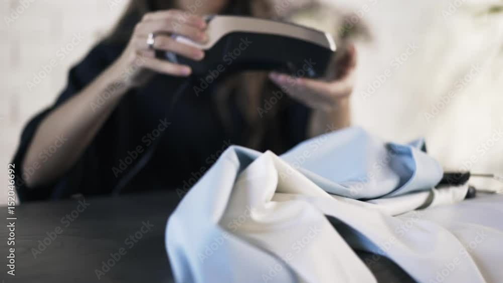Close up of an unrecognizable woman s hand paying for shirts with a credit card. Locked down real time close up shot Close up of an unrecognizable woman s hand paying for shirts with a credit card. Locked down real time close up shot