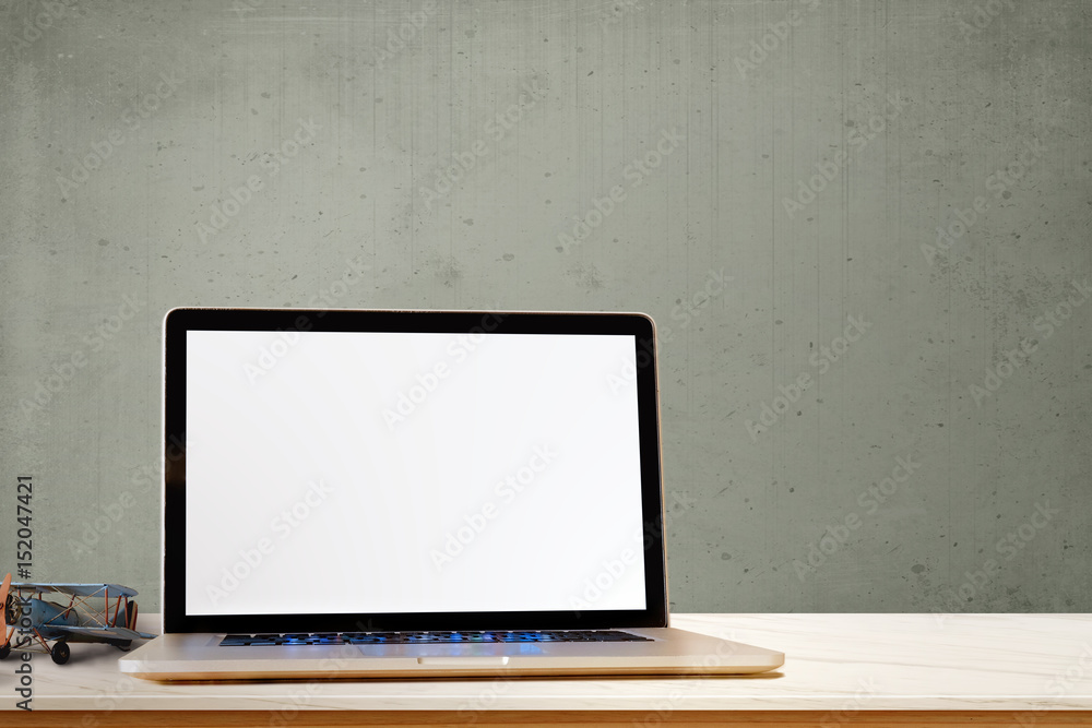 Laptop showing blank screen computer, antique toy on wood table. Copy space for product or graphic montage. Laptop showing blank screen computer, antique toy on wood table. Copy space for product or graphic montage.