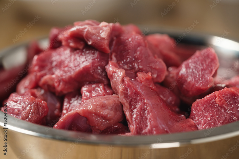 raw beef in bowl closeup, shallow focus