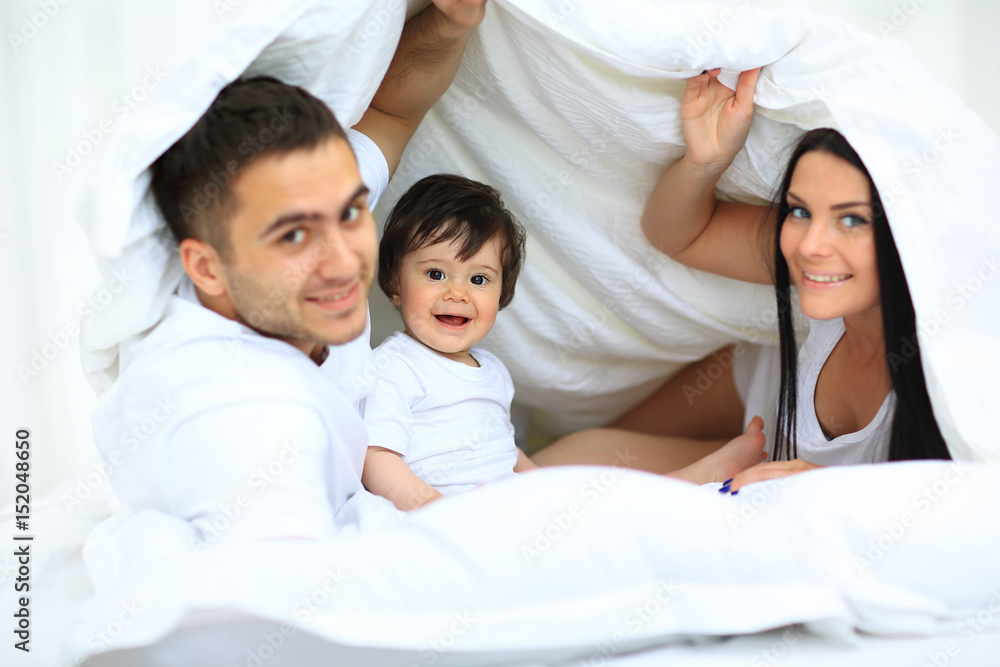 Attractive young family in the bedroom