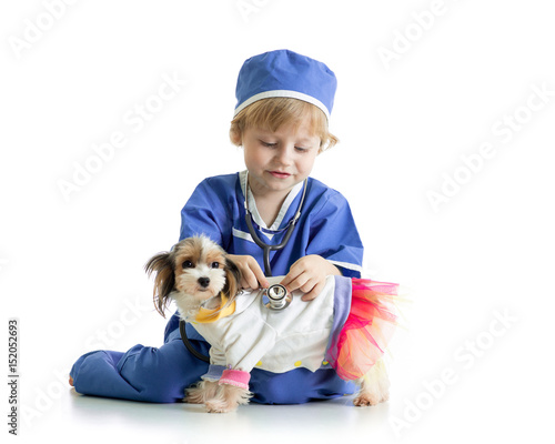 little boy examining puppy ...