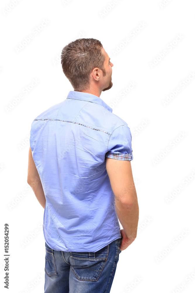 Young man from the back - looking at something over a white back Young man from the back - looking at something over a white back