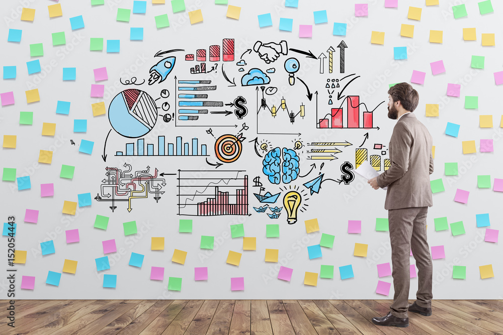 Businessman and scheme with sticky notes Businessman and scheme with sticky notes